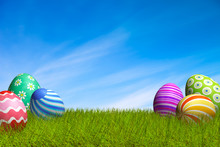 Decorated Easter Eggs In The Grass Under A Blue Sky