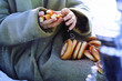 girls hands in an old coat a bunch of bagels