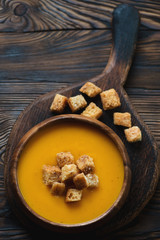 Sticker - Pumpkin soup served with croutons on a wooden chopping board