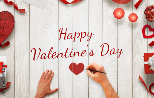 Man Hand Painting Happy Valentines Day Message On A Wooden