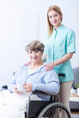 Wall Mural - Young caregiver and senior woman