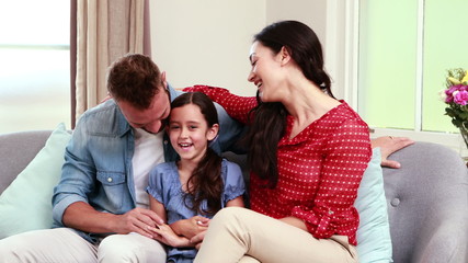 Canvas Print - Happy family discussing on sofa