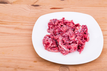 Wall Mural - Fresh and nutritious minced raw meat and bones dog food on plate