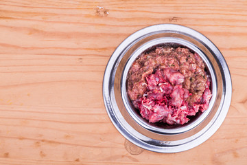 Fresh and nutritious minced raw meat and bones dog food in bowl