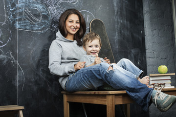 young hipster teenage girl sitting with her brother in classroom multinational