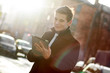 © dmitry_osipov - Business man in coat using tablet