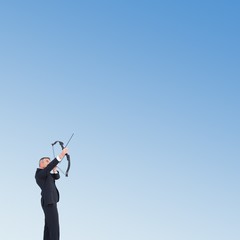 Poster - Composite image of businessman shooting bow and arrow