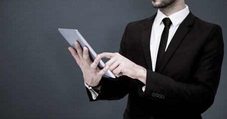 Sticker - Composite image of mid section of a businessman using tablet