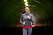 Strong powerful woman runner exercising in city urban environment fitness tough intense serious