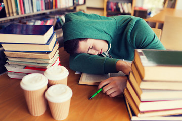 Wall Mural - tired student or man with books in library