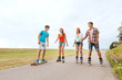 © Syda Productions - happy teenagers with rollerblades and longboards