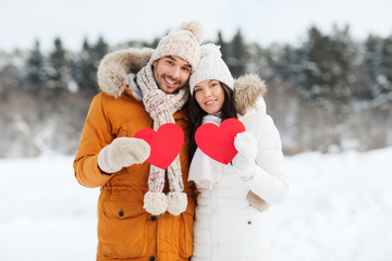 Poster - happy couple with red hearts over winter landscape