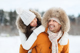 Fototapeta Las - happy couple having fun over winter background
