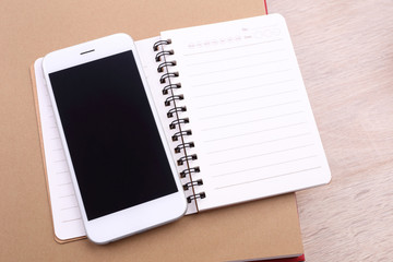 Poster - Blank screen smartphone and note book on wooden background