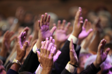 Wall Mural - raised up a human hands at the event