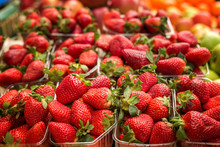 Fresh Red Strawberries Arranged In Baskets Ready For Sale At Marketplace. Shallow Depth Of Field.