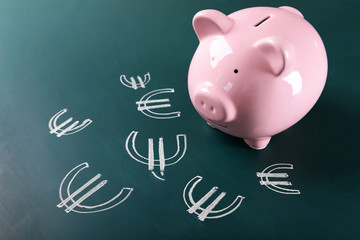 Poster - Piggy bank on chalkboard with Euro currency symbols