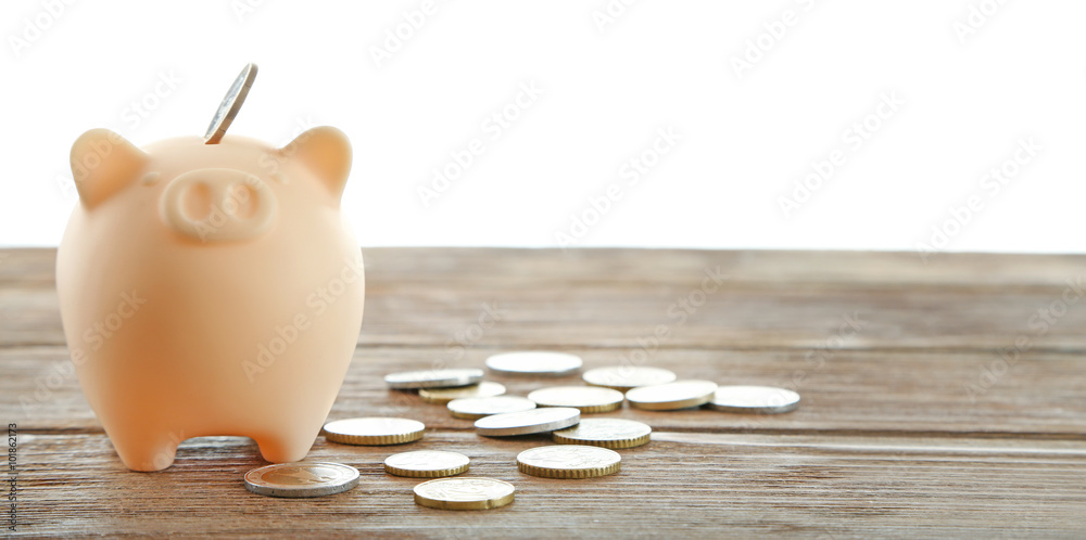 Piggy bank with coins isolated on white