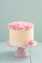 Ivory Fondant Covered Cake With Pink Sugar Roses On Cake Stand