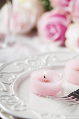 Wall Mural - Pink candle and roses on the table