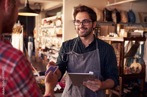 Fotografie, Obraz Sales Assistant With Credit Card Reader On Digital Tablet