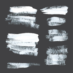 Abstract realistic strokes drawn thick white paint on black pape