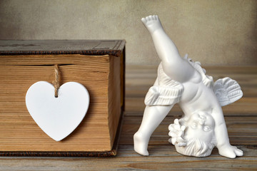 Wall Mural - Angel figurine and heart shape decoration. Love concept.