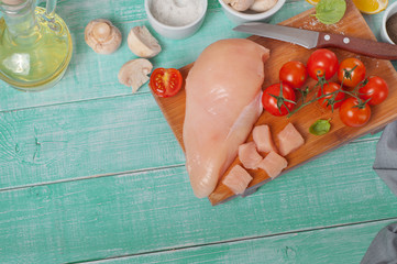 Wall Mural - chicken breast, cherry tomatoes, basil leaves, mushrooms and oil