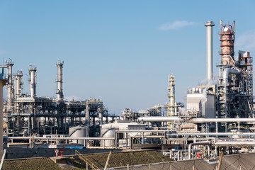 chimneys of oil refinery in winter against a cloudy sky