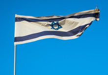 Israelian Flag Against Blue Sky In Tel Aviv, Israel