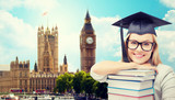 Fototapeta Big Ben - student in trencher cap with books over london