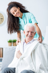 Wall Mural - Nurse supporting ill old man