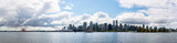 Fototapeta Miasto - skyline of vancouver city behind the sea during a sunny day of summer with a beautiful sky seen from stanley park british columbia canada 
