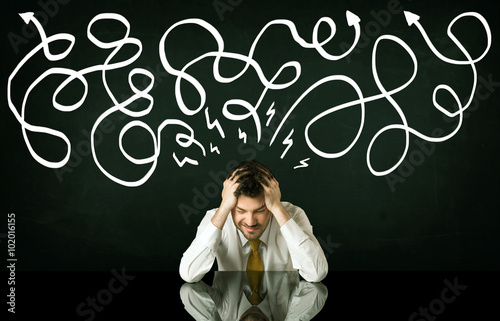 Fotografie, Obraz Depressed businessman sitting under drawn direction lines
