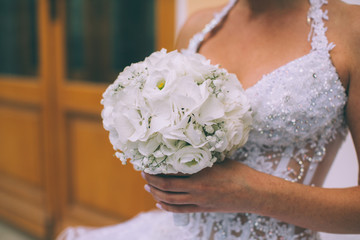 Beautiful wedding bouquet in hands of the bride