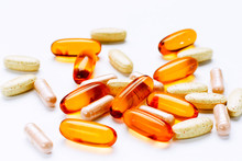 Biological Additives To Food, Vitamins For A Healthy Lifestyle, Capsules An Omega 3 With Cod-liver Oil, Transparent Orange Color An Embankment On A Light Background Close Up