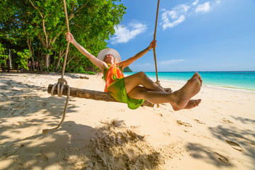 Wall Mural - Woman swing on the beach