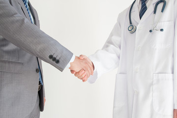 Wall Mural - Doctor and businessman shaking hands