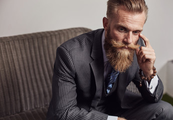 Brutal beard man on sofa