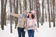 © EdNurg - couple in love kissing in forest in winter sweaters. The guy ind