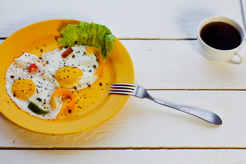 Two fried eggs for healthy breakfast on white wooden table