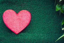 Red Heart On A Green Background For Valentine's Day.