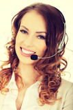 Fototapeta Uliczki - Smiling support phone operator in headset.