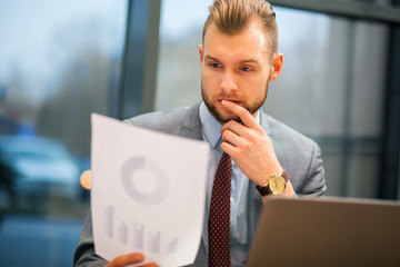 Portrait of a businessman reading a document