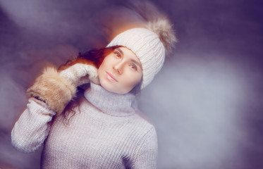 Wall Mural - A girl in warm winter sweater and a hat.