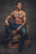 © Fxquadro - Shirtless muscular man with tattooes on his body.