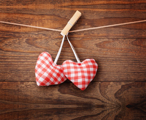 Two hearts and wooden background.