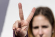 © Alonso Aguilar - Young woman showing the sign of peace or victory