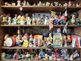 Fototapeta Uliczki - Shelves full of creepy clown toys - landscape photo