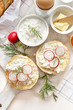 Sandwich with cottage cheese with fresh radish and dill on the white board 